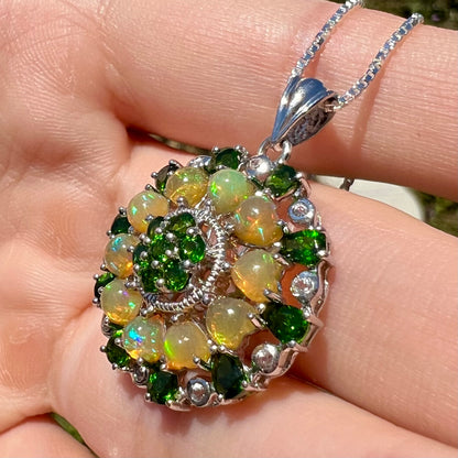 Angled close-up of an Ethiopian opal and chrome diopside necklace, shown in the sun.