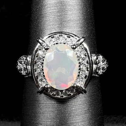 Close-up of women's sterling silver Ethiopian opal and CZ halo ring on display