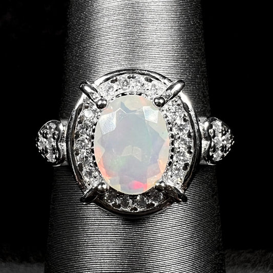 Close-up of women's sterling silver Ethiopian opal and CZ halo ring on display