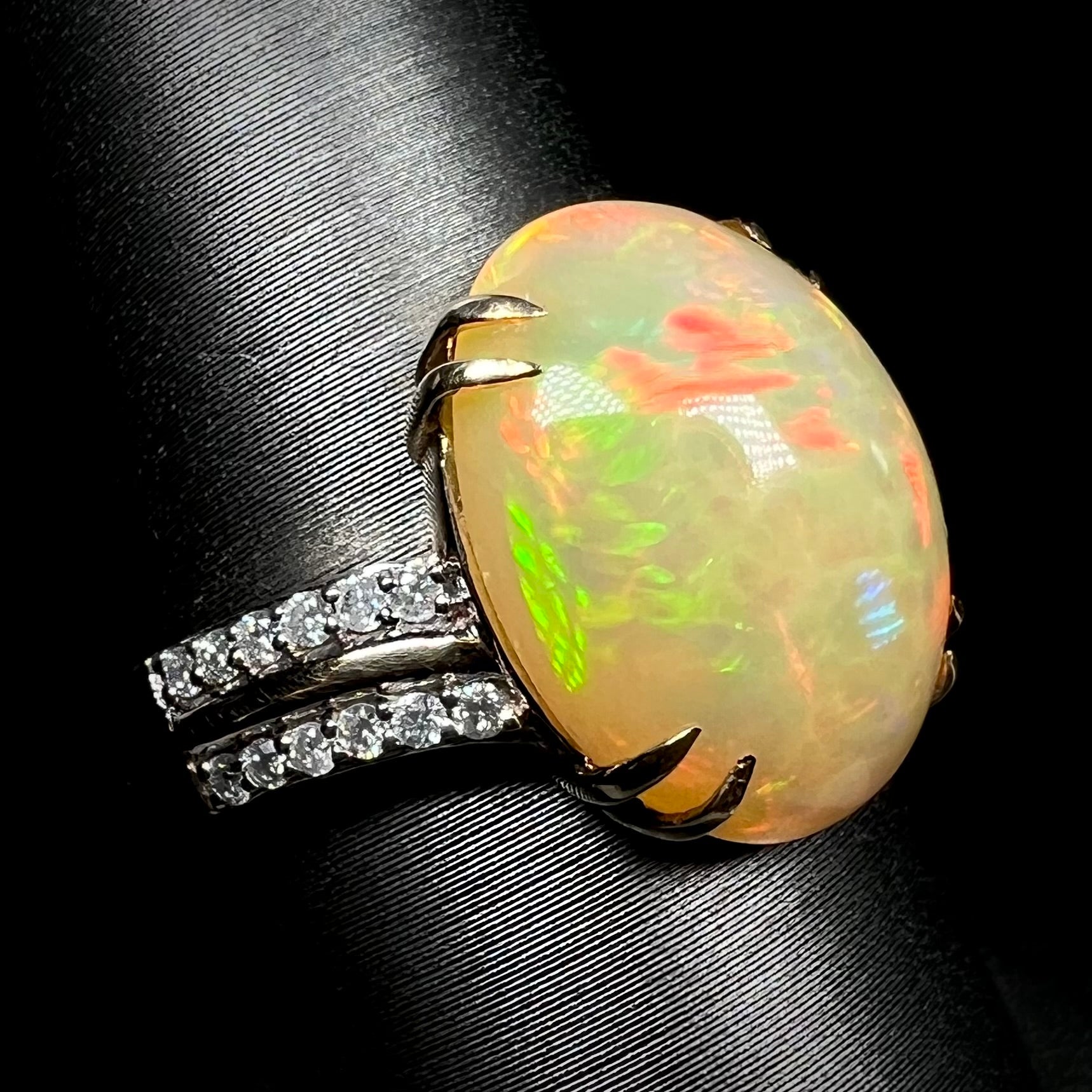 14k gold Ethiopian opal and diamond cocktail ring with split double-prong design on display