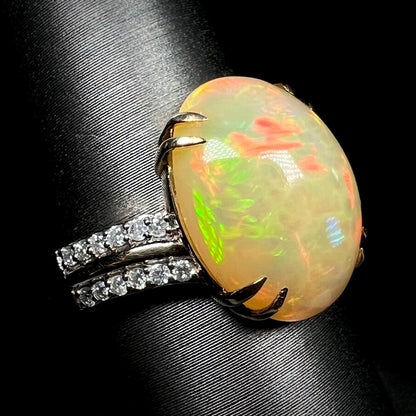 14k gold Ethiopian opal and diamond cocktail ring with split double-prong design on display
