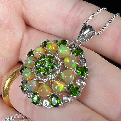 Angled close-up of an Ethiopian opal and chrome diopside pendant.