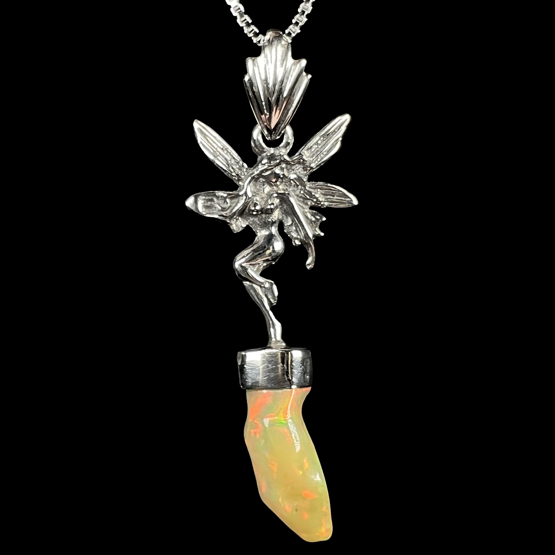 A sterling silver fairy necklace with an Ethiopian fire opal crystal, shown close-up against a black background.