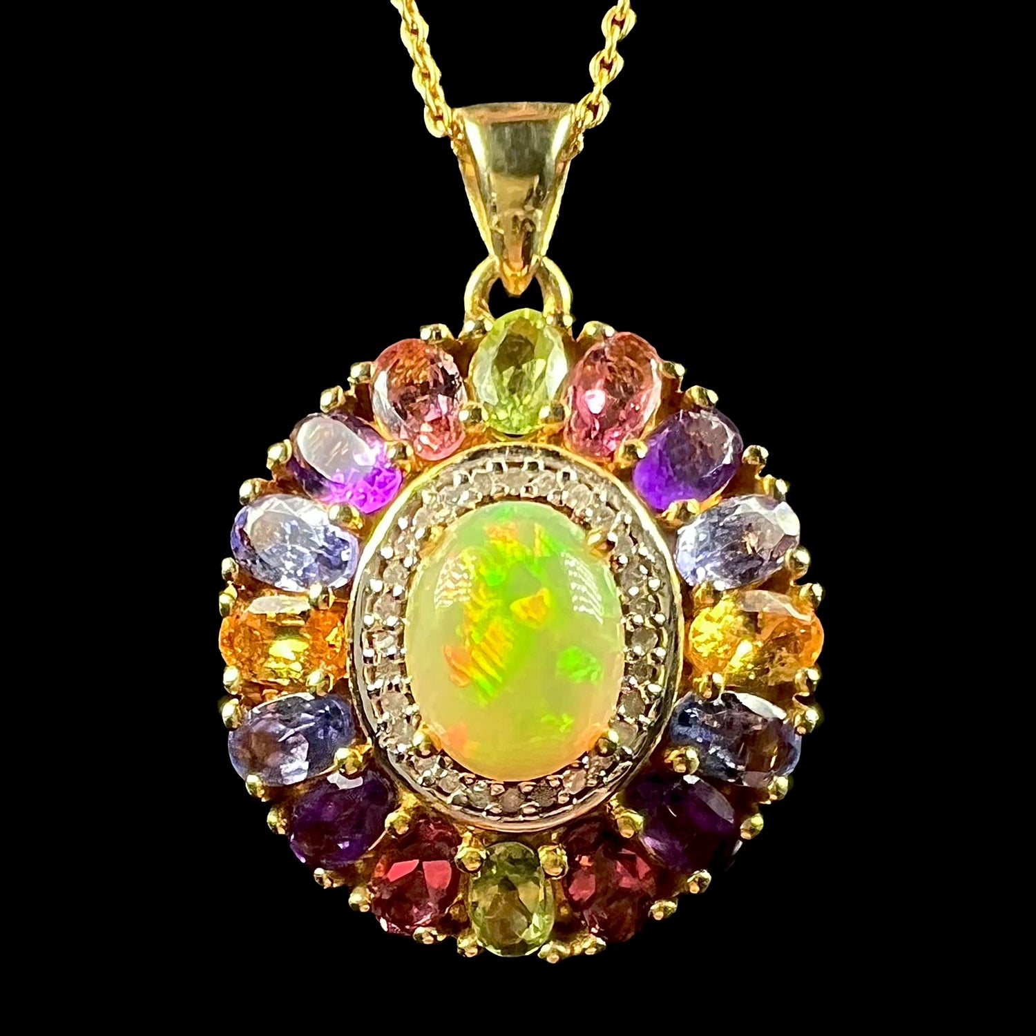A gold plated sterling silver Ethiopian fire opal and multi-gemstone halo pendant shown from the front.