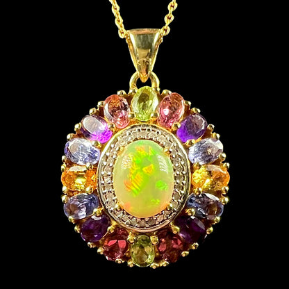 A gold plated sterling silver Ethiopian fire opal and multi-gemstone halo pendant shown from the front.