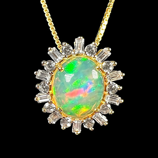 Macro close-up of dainty 14k yellow gold Ethiopian opal pendant with white sapphire halo on box chain.
