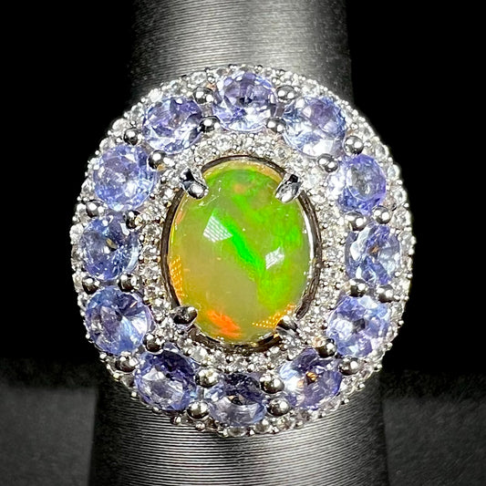 Front view of ring with Ethiopian fire opal with tanzanite halo and two white zircon halos.