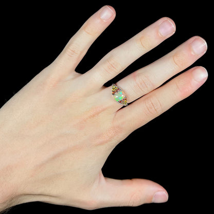 A ladies' silver ring set with a cushion cabochon cut Ethiopian fire opal stone and citrine accents.