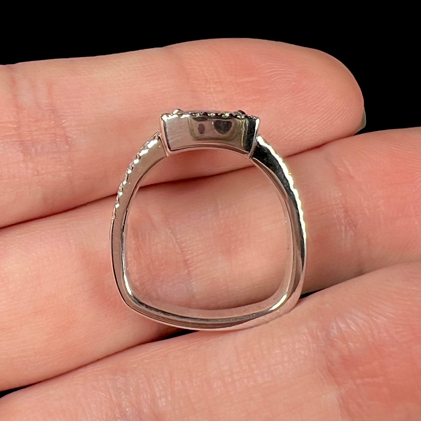 The profile-view of a white gold opal engagement ring made with a Euro shank.