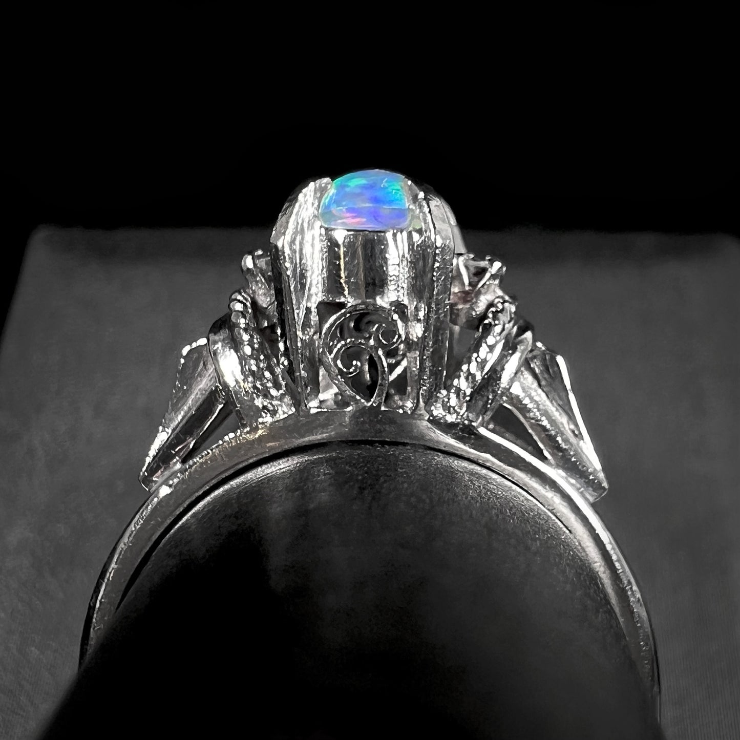 The gallery view of platinum filigree on a Mexican jelly opal and diamond ring.