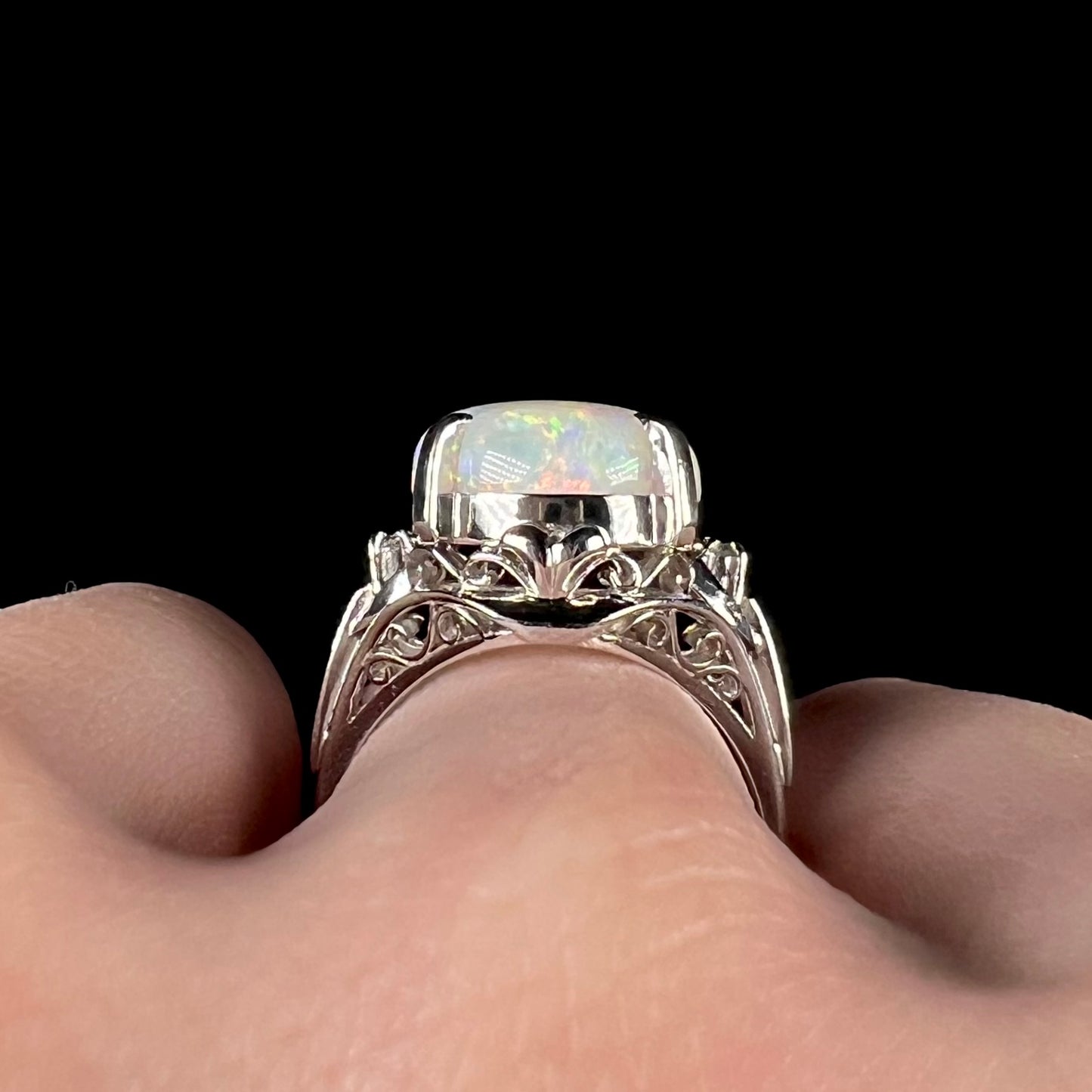 The side view of filigree details on an opal engagement ring.