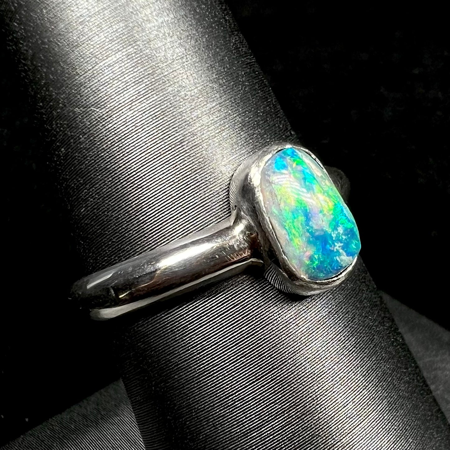 Fine silver Australian crystal opal ring with green and blue colors on ring display