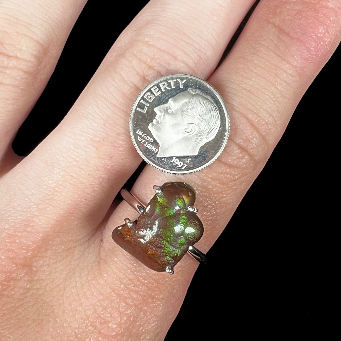 Fire agate ring worn with US dime for scale, showing stone size and detail.