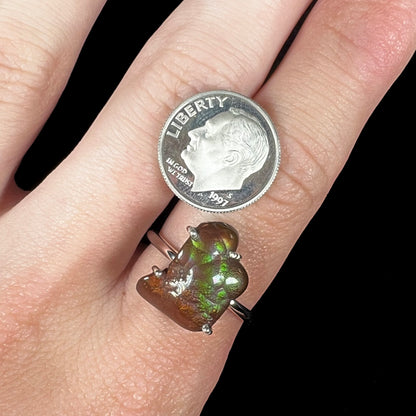 Fire agate ring worn with US dime for scale, showing stone size and detail.