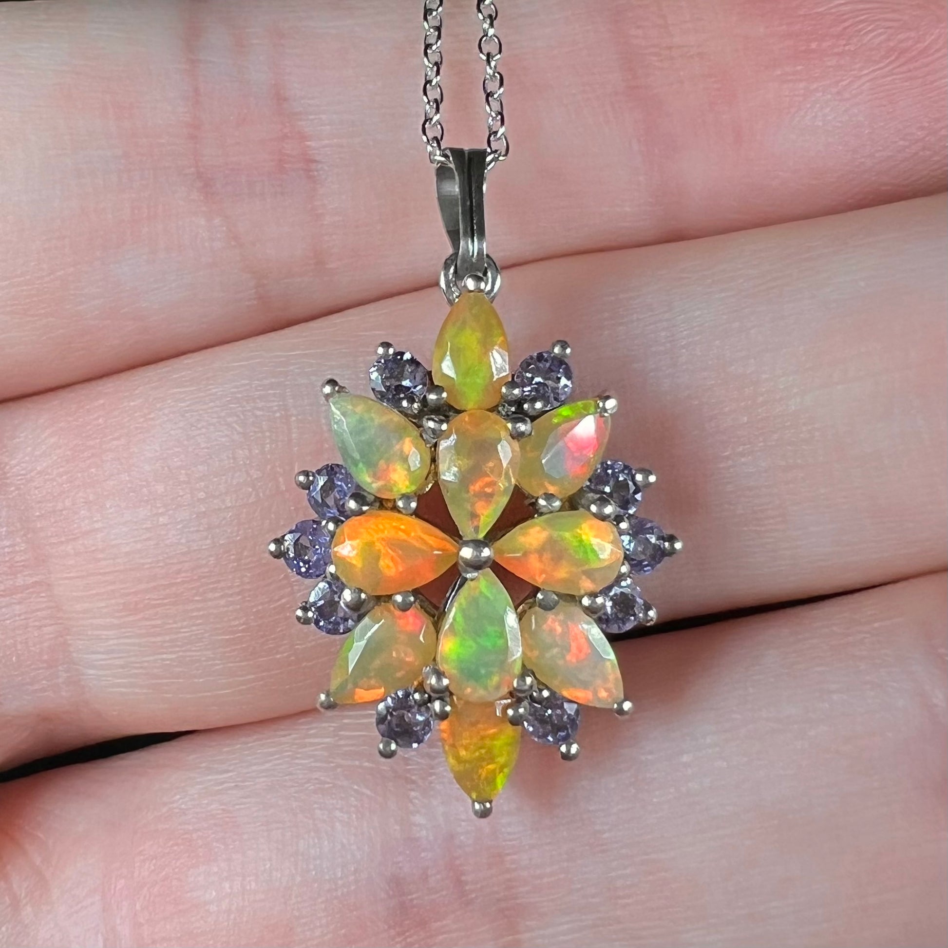 Close-up front view of an Ethiopian fire opal necklace with tanzanite accents.