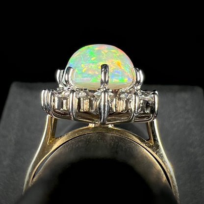 A profile view of a 4.30ct Lightning Ridge fire opal engagement ring, showcasing the white gold diamond halo on a yellow gold shank.