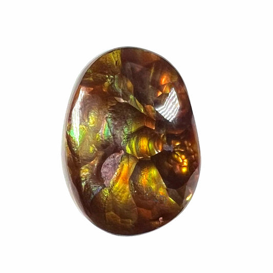 A loose, oval cabochon cut fire agate gemstone.  The stone is bubbly green with blue overtones.