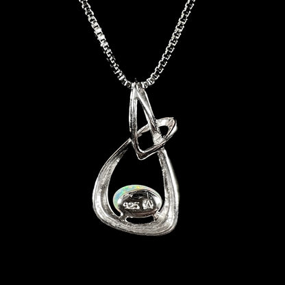A ladies' sterling silver pendant set with an oval cabochon cut natural white crystal opal.