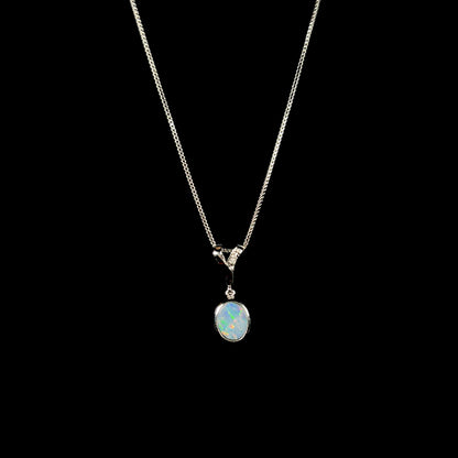 A sterling silver necklace set with a natural black opal doublet and white zircon accent stones.