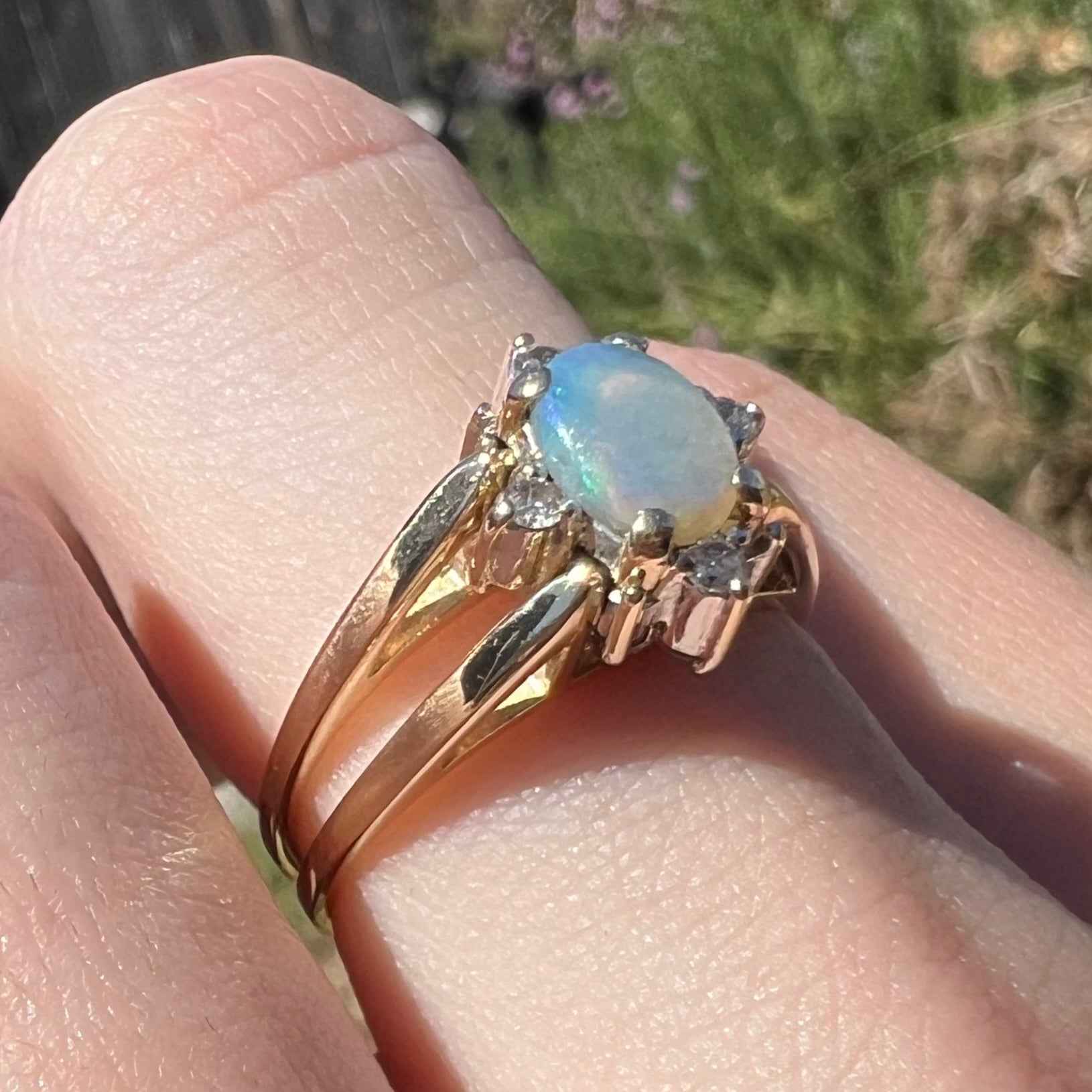 14k gold highly-directional Australian opal and diamond flip ring, worn on finger in sunlight and shown close-up