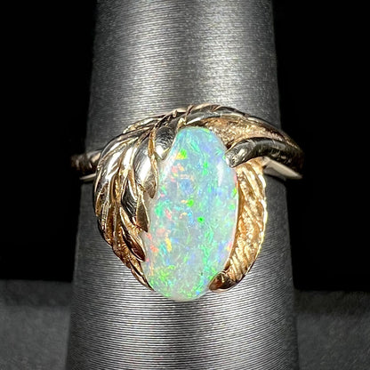 A retro, 1980's-style yellow gold opal leaf-design ring.