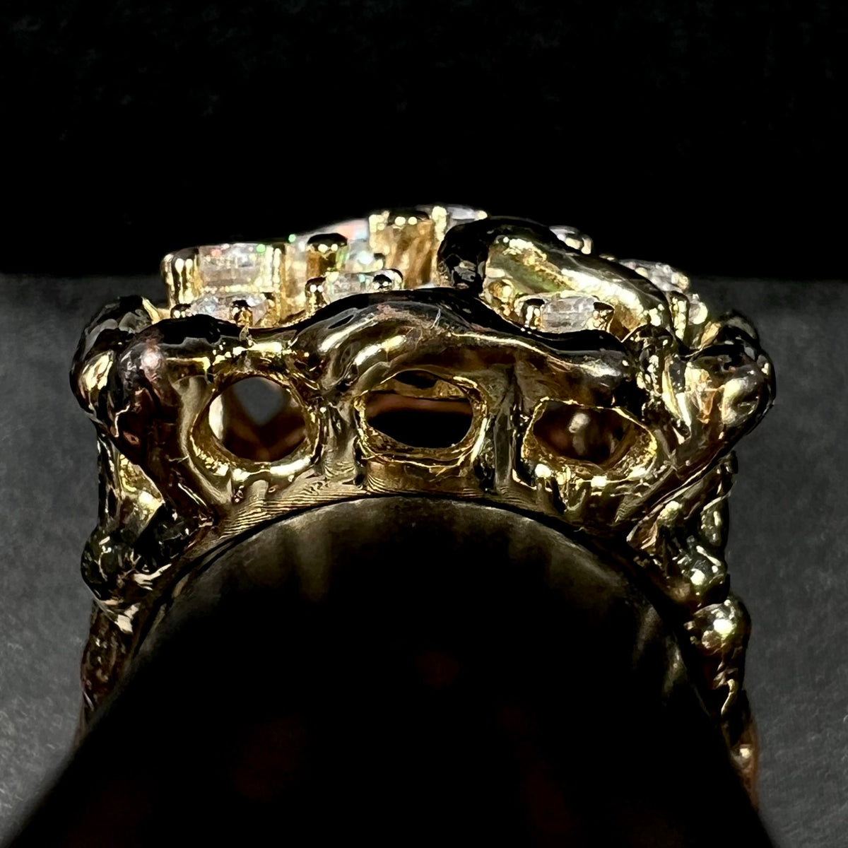 Gallery view of gold-plated brutalist-style men's ring set with cubic zirconia stones, shown on ring display.