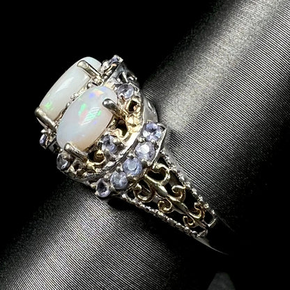Side view of gold-tone filigree details on a sterling silver Australian opal and tanzanite ring.