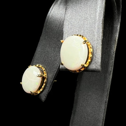 Ribbed gold-tone Australian opal stud earrings with cracks on earring display