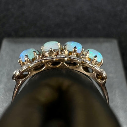 Side gallery view of antique 9k gold Victorian-era opal and pearl ring, shown on ring display