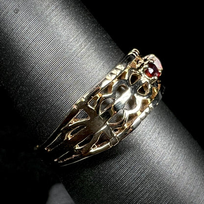 Side view of a gold band with an open, woven design.