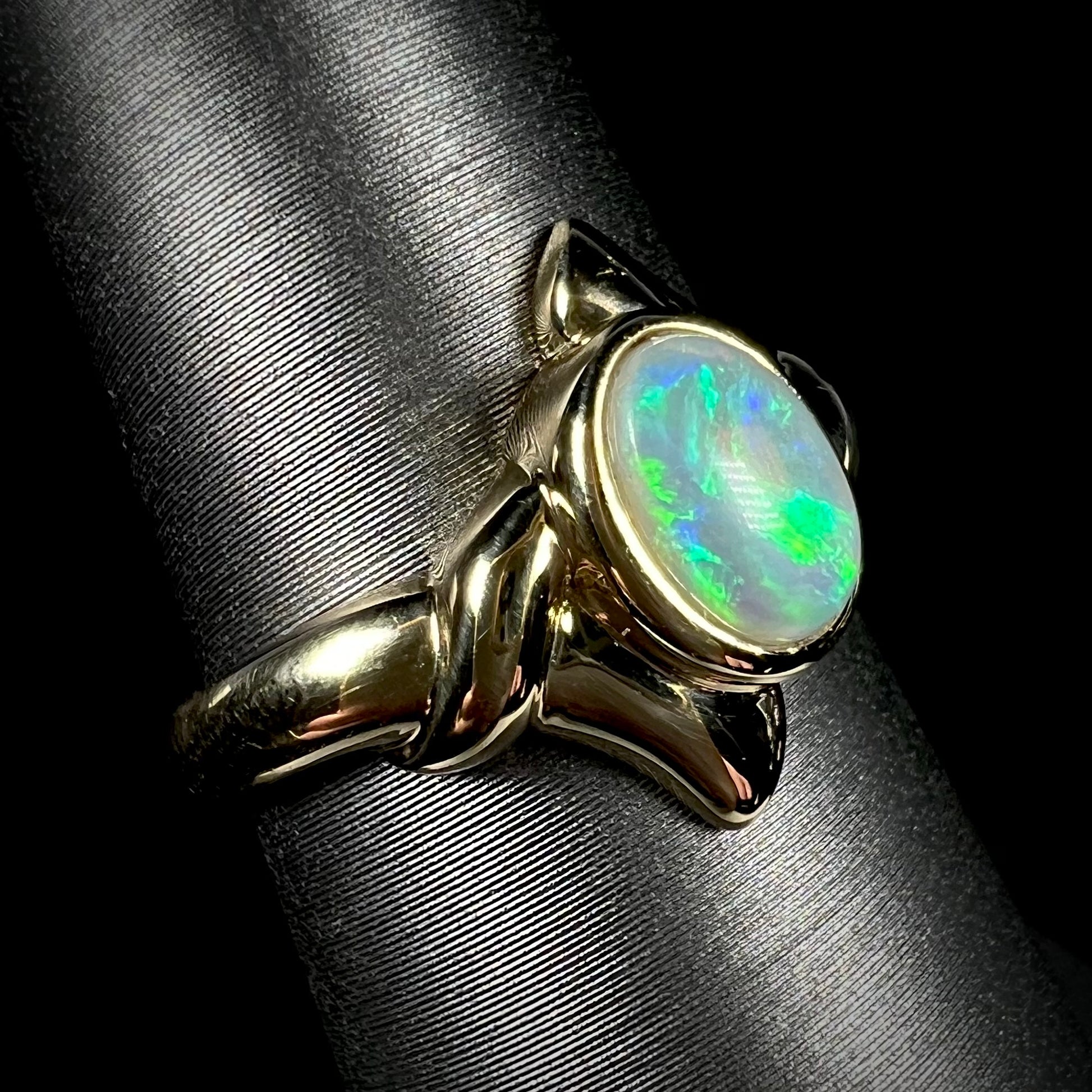 A green crystal opal set in an 18 karat yellow gold solitaire ring.