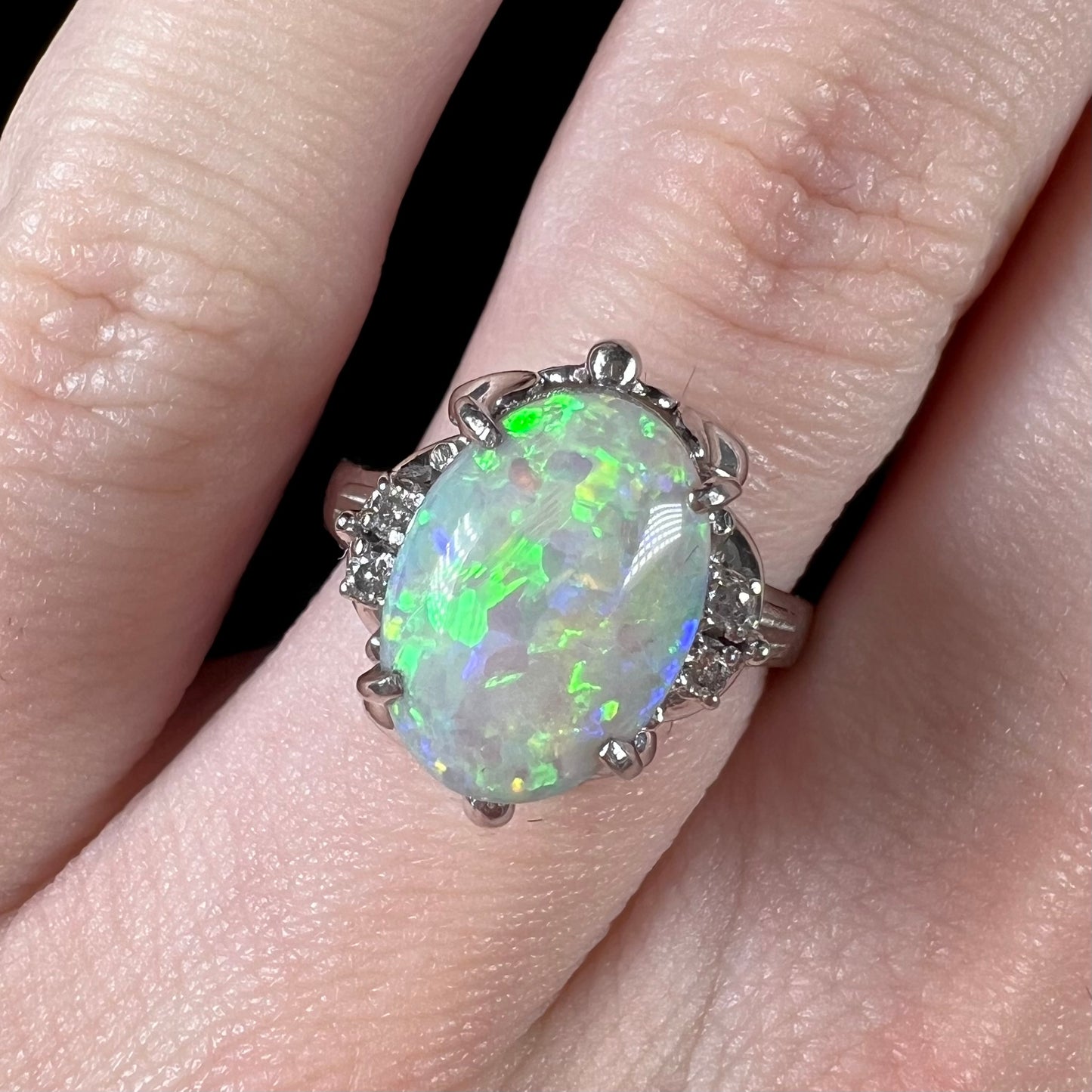 A green opal and diamond-accented platinum ring.  The ring is an ornate Japanese style.