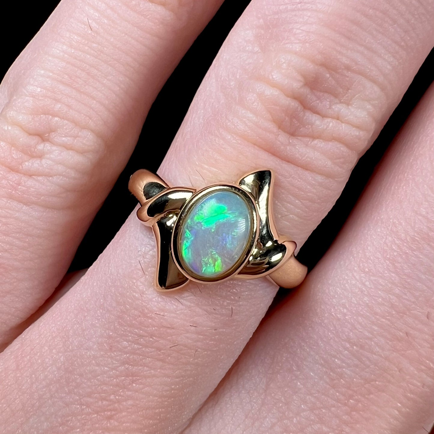 A green crystal opal engagement ring cast in 18 karat yellow gold.