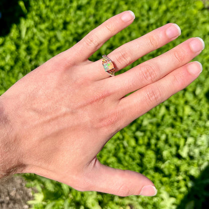 A ladies' silver ring set with a cushion cabochon cut Ethiopian fire opal stone and citrine accents.