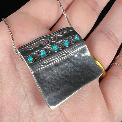 A handmade sterling silver five-stone opal necklace with a hammered finish by Israeli designer, Shablool Didae.