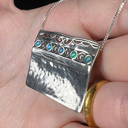 A handmade sterling silver five-stone opal necklace with a hammered finish by Israeli designer, Shablool Didae.