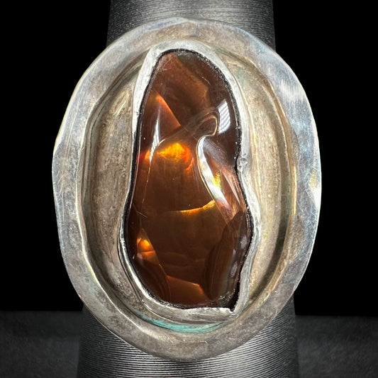 A handmade sterling silver fire agate ring shown from the front.