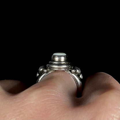 Side profile gallery view of a handmade silver Boho ring worn on a finger.