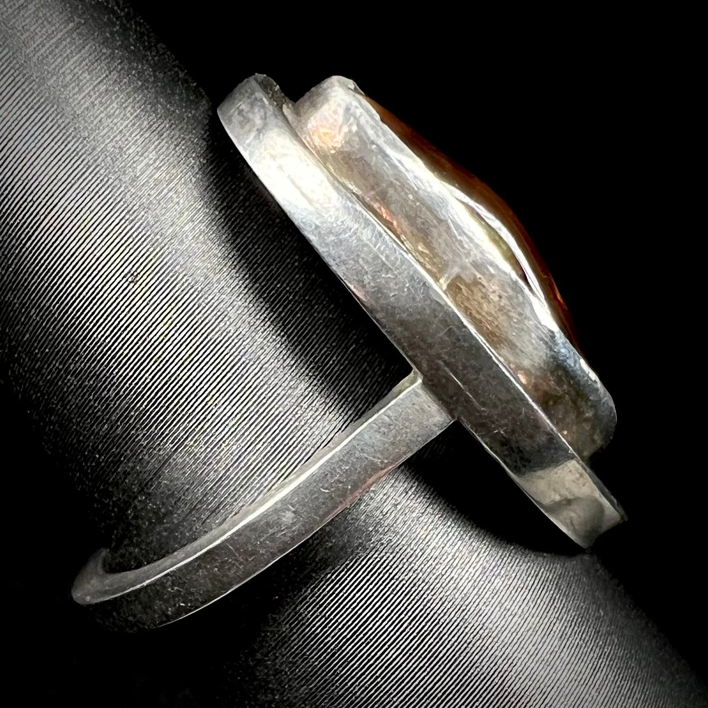 Side view of a handmade sterling silver fire agate ring.