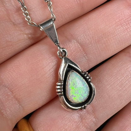 A pear shaped sterling silver Navajo pendant set with a green Australian opal made by artist, Chris Charley.