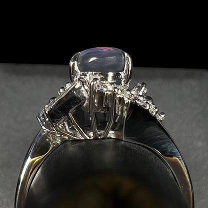 Gallery view of a high-profile Japanese platinum ring prong-set with opal and diamonds, shown on ring display.