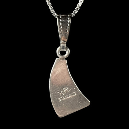 Back view of silver necklace with opal inlay and 'HR' stamp, set against a black background.