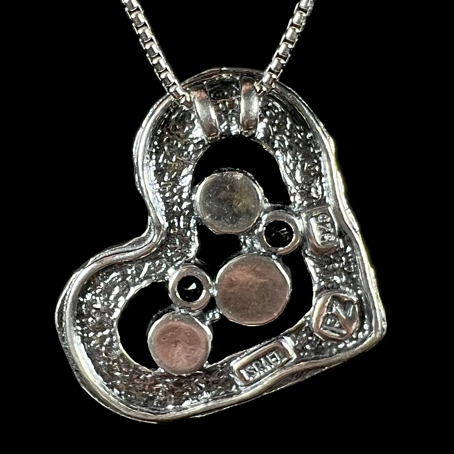 Back side of a sterling silver heart necklace by Paz Creations, hallmarked, "ISRAEL", "PZ", and "925".