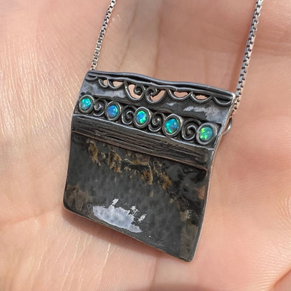 A handmade sterling silver five-stone opal necklace with a hammered finish by Israeli designer, Shablool Didae.