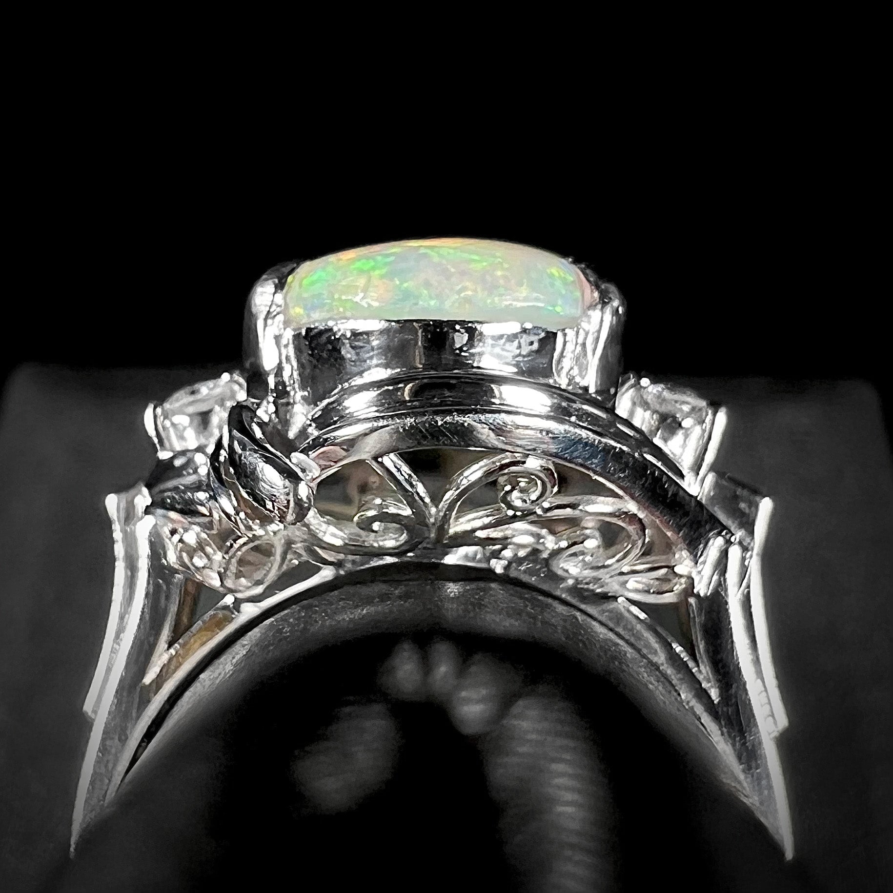 The gallery view of a platinum opal ring imported from Japan showcasing intricate filigree designs.