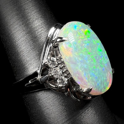 A Japanese opal ring made from platinum set with diamond accents.