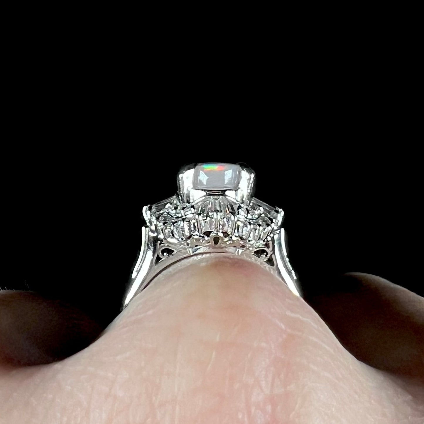 The gallery view of a Japanese-crafted platinum filigree and opal ring with diamond accents.