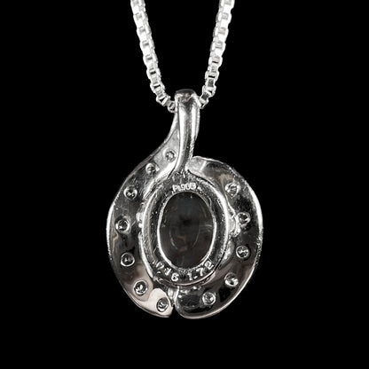 Back side of Japanese platinum pendant showing "Pt900", "0.16", and "1.72" hallmark stamps, as well as the back of the mounted black crystal opal.