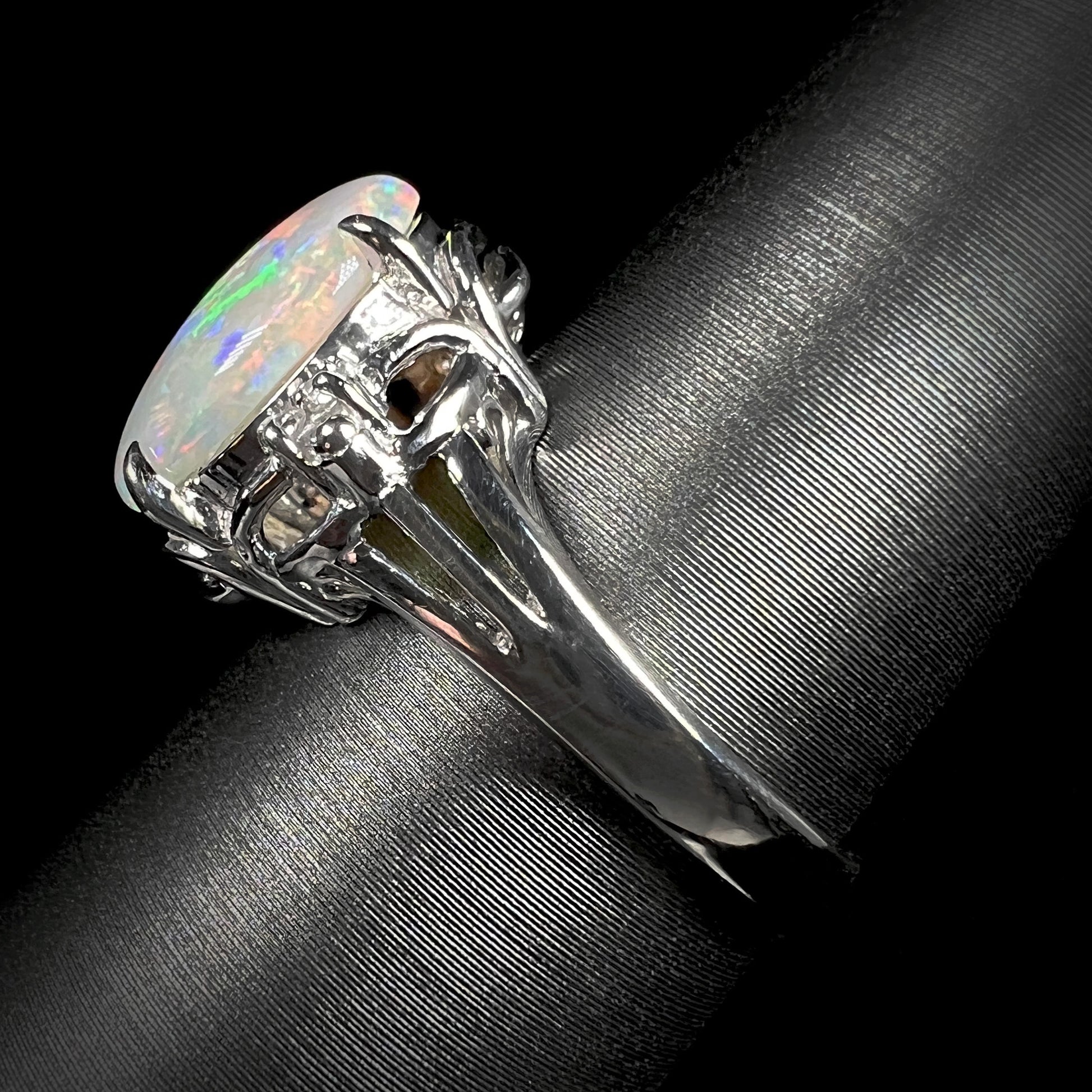 The side view of a Japanese-made platinum opal and diamond ring.