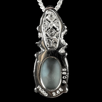 Back side view of a Japanese platinum pendant with pineapple design showing back of black opal stone and hallmark stamps reading "Pt900", "2.66", and "0.35".